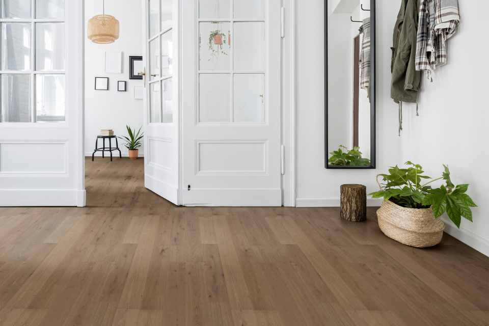 solid hardwood flooring in modern white entryway